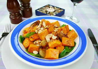 Roasted pumpkin and onion salad with spinach and almonds.