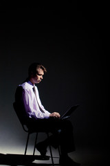 Photo of businessman working in dark room