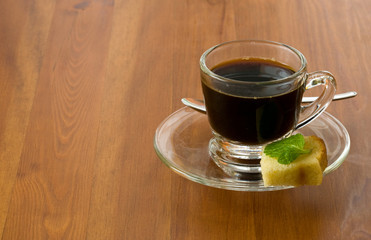 a coffee cup with sweet piece of cake