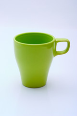 Green mug of modern design on a white background