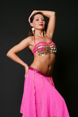elegant dancer in stage costume over black