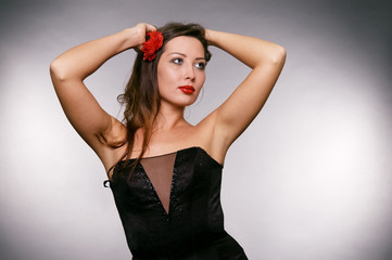 lovely woman posing against grey background