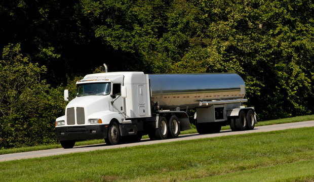A fuel tanker transport truck on a highway, fuel transportaion