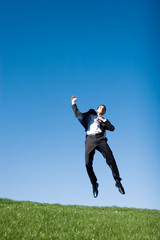 Businessman jumping in the air