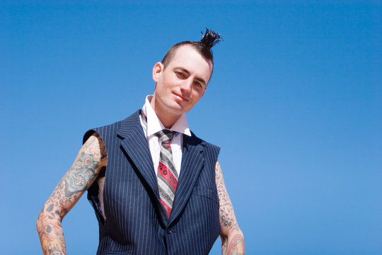 Man with mohawk style haircut and alternative fashion outfit