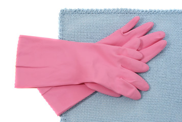 pink rubber gloves over blue tablecloth, white background