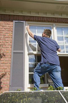 Contract painter painting exterior trim to speed up selling