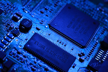 Blue computer board with chips and components