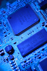 Blue computer board with chips and components