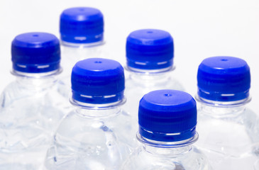 Plastic water bottles with blue lids