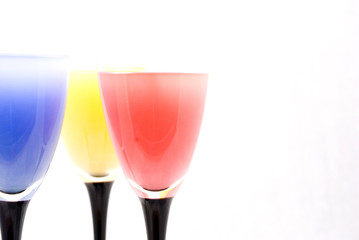 Tall wine glasses with colour water
