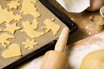 christmas cookies cut out of dough on oven rack, ingredients