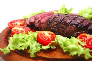 roasted beef meat steak on wooden plate close-up