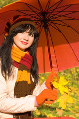 Young pretty woman in the autumn park.