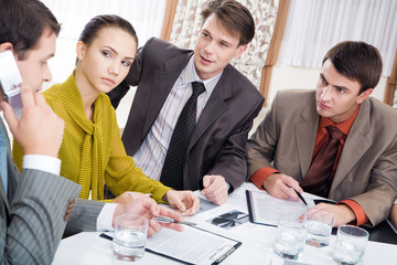 Portrait of serious co-workers looking at their partner