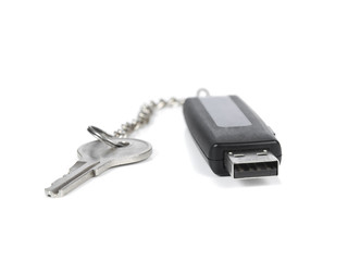 A pendrive keyring with a key over a white background.