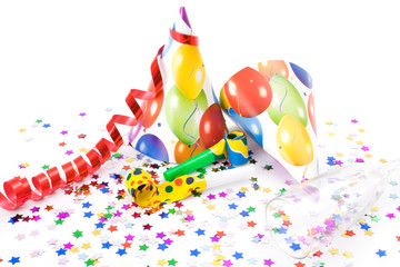 Party hats, horns or whistles and confettis on white background.