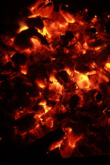 Close-up of smouldering embers on dark background