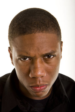 An angry young black man closeup looking at camera