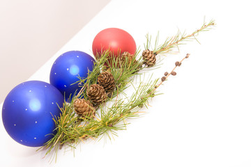 green conifer with cones, baubles and white copy space