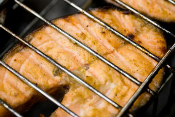 Appetizing fish on a grill. Outdoor picnic. Close-up.
