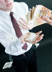Businessman receiving money, isolated on black background