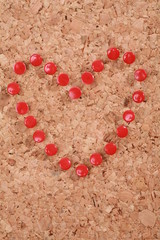 a heart made out of thumbtracks on a corkboard...........