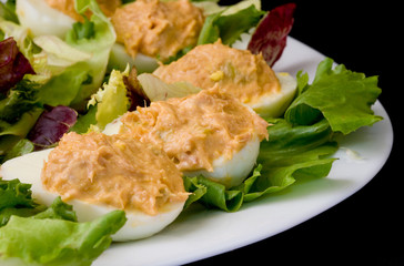 white platter with boiled eggs filled with tunna sauce