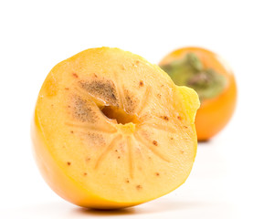 Fresh appetizing persimmon on a white background