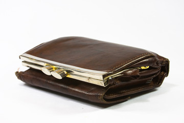 an old brown leather wallet isolated on white