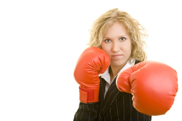 Blonde Frau im Jackett mit roten Boxhandschuhen