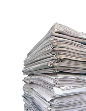 Newspaper stack on white background.