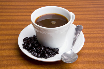 Cup of expresso coffee on a wooden table