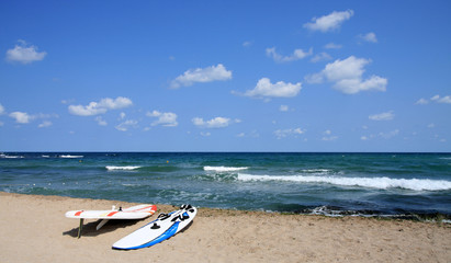 Fototapeta na wymiar Two board for windsurfing on the beach. Black Sea, Bulgaria.