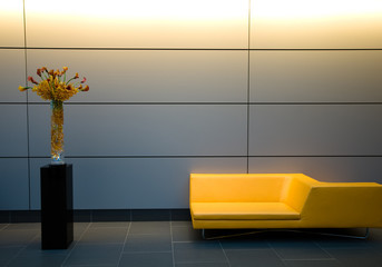 designer yellow couch with floral bouquet