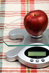 fresh apple placed on a scale