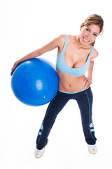 Fototapeta premium Young woman holding an blue exercise ball