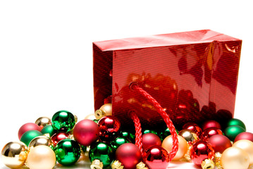 A pile of Christmas ornaments in a gift bag.