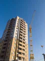 crane on construction of building new brick house