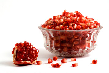 Goblet full of pomegranate arils isolated on white background