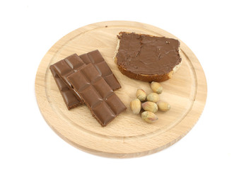 chocolate and bread on wooden plate