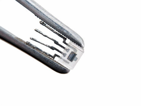 Optocoupler in pincers electronic assembly macro view
