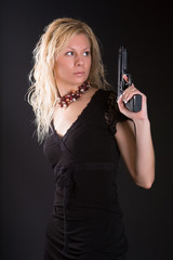 Beautiful girl with the big black pistol