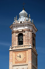 Fototapeta premium Medieval church clock and bell tower against blue sky