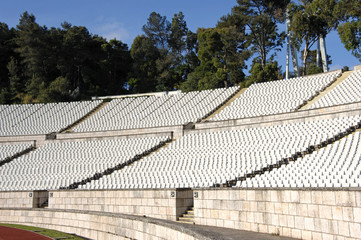 Empty stadium with lots of white chairs