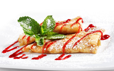 Pancakes Served with Berries Syrup and Fresh Mint Leaves