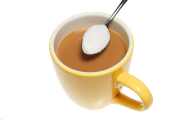 Mug of coffee and spoonful of sugar