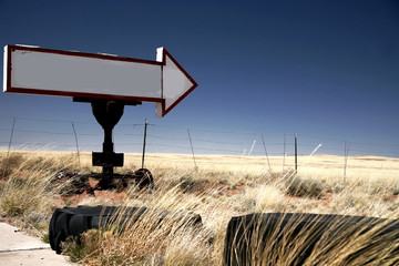 vintage blank sign arrow in field of rye