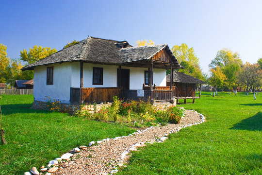 An old house with a long cobble ride in front from Romania