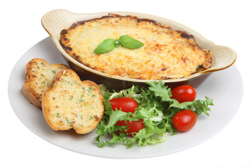 Individual lasagna with garlic bread and salad
